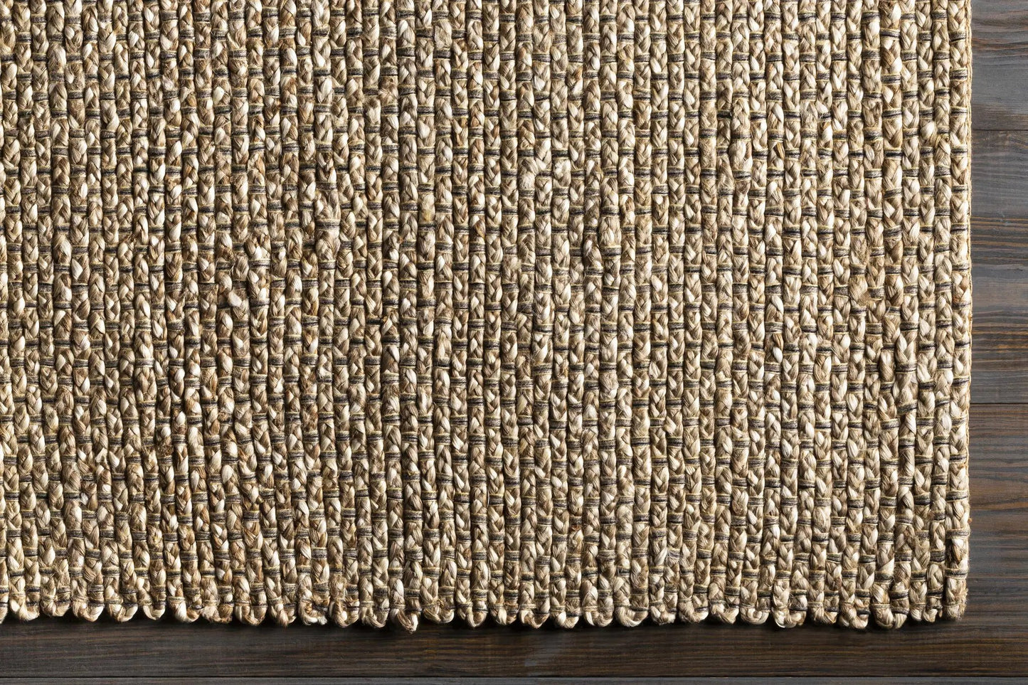 Caspar Hand Woven Natural Jute Area Rug earthy tones, textured weave on wood floor on Tampa Home & Garden Store