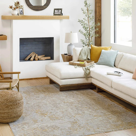 Cayhagan Mustard Luxe Rug Contemporary under beige sofa in a bright living room Boutique Rugs on Tampa Home & Garden Store