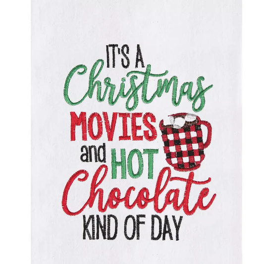 Kitchen towel with Christmas Movies design in red and green embroidery and a plaid mug on Tampa Home & Garden Store