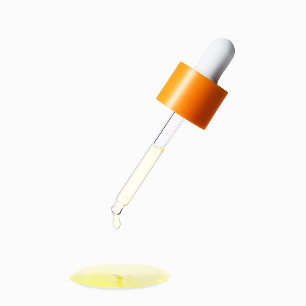 Serum dropper bottle with orange cap and pale yellow liquid on Tampa Home & Garden Store