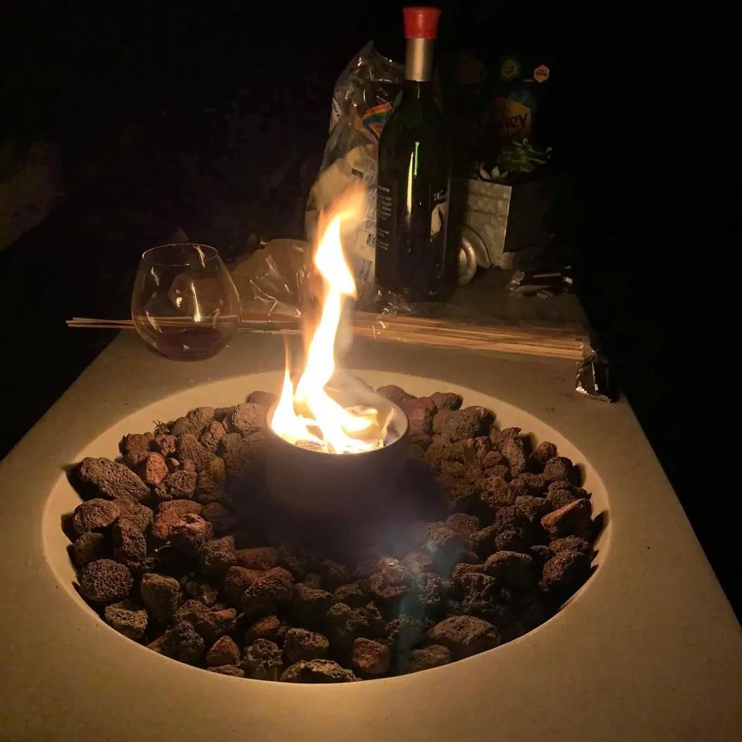 City Bonfires portable outdoor burner in black metal inside circular lava-rock fire pit on Tampa Home & Garden Store