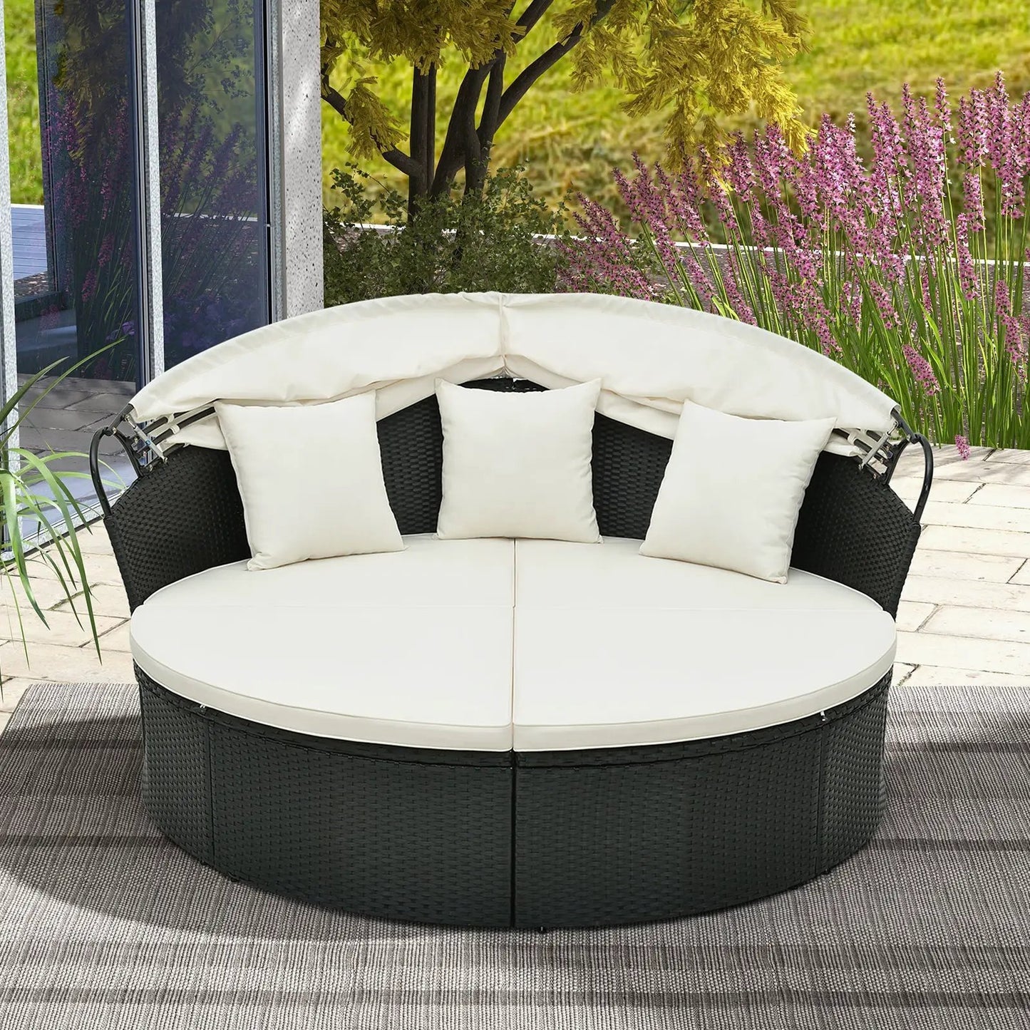 Clamshell round daybed with retractable canopy; white cushions, black wicker base on Tampa Home & Garden Store