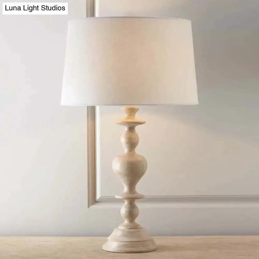 White resin nightstand lamp with fabric shade and pedestal base on Tampa Home & Garden Store