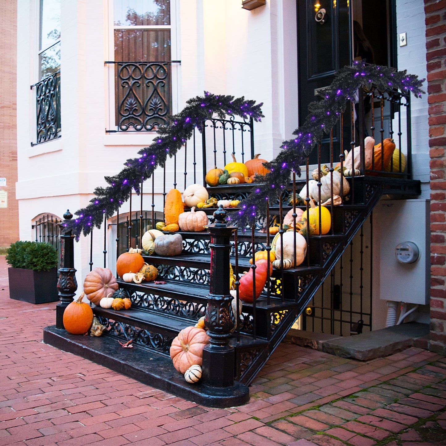 9 ft prelit Halloween garland with purple LEDs draped over iron railing amid pumpkins DirectDeals on Tampa Home & Garden Store