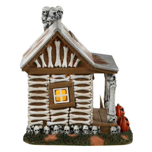 Skeleton Cottage Spookytown village house with snow-dusted logs, The Country Christmas Loft on Tampa Home & Garden Store
