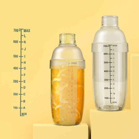 Two Shaketea plastic cocktail shakers with measurement marks and lemon-filled bottle on Tampa Home & Garden Store