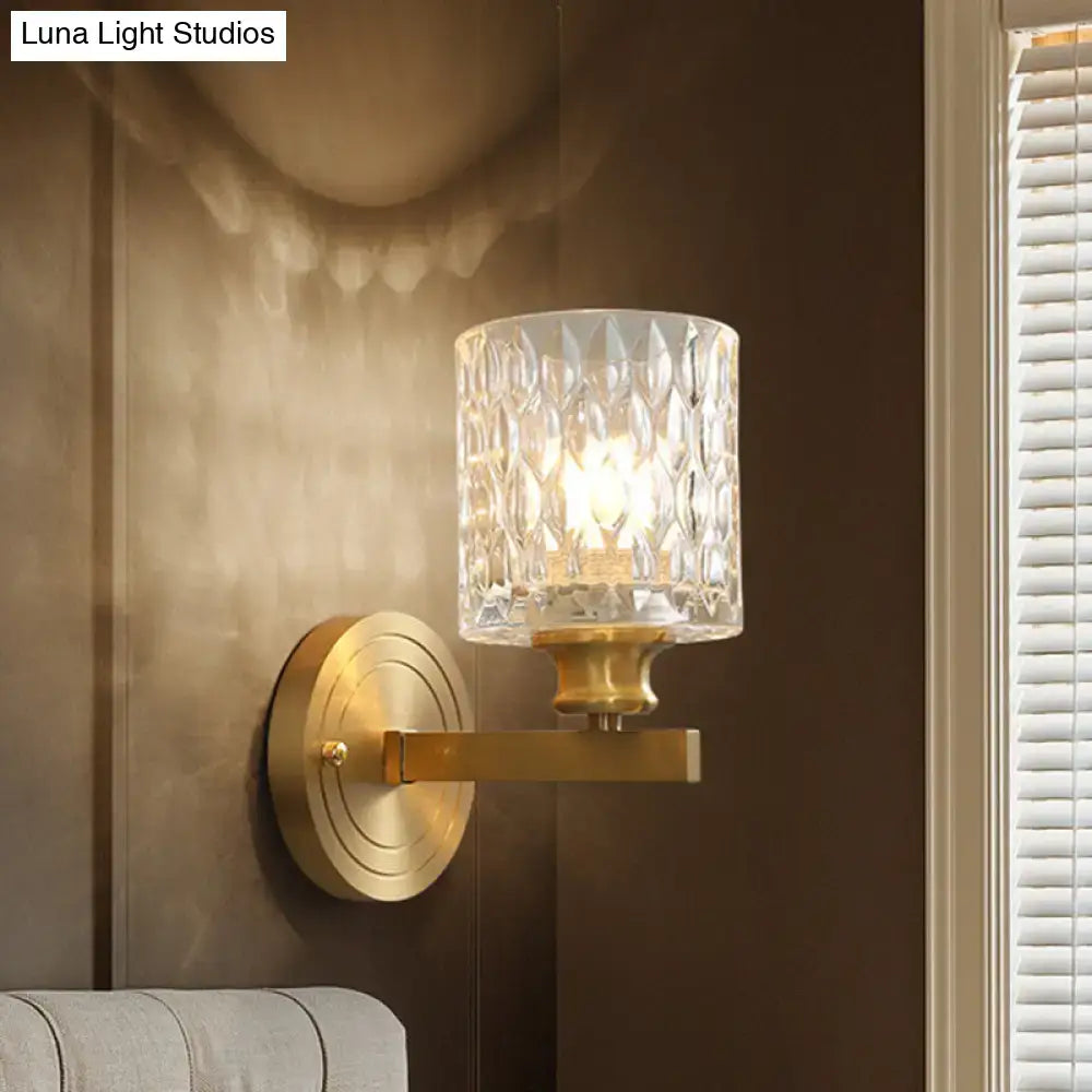Gold cylindrical glass wall sconce with diamond-cut shade and brass mount by Decorbites on Tampa Home & Garden Store