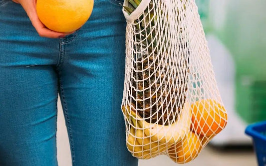 Reusable organic cotton mesh shopping bag with oranges inside, natural beige tote on Tampa Home & Garden Store