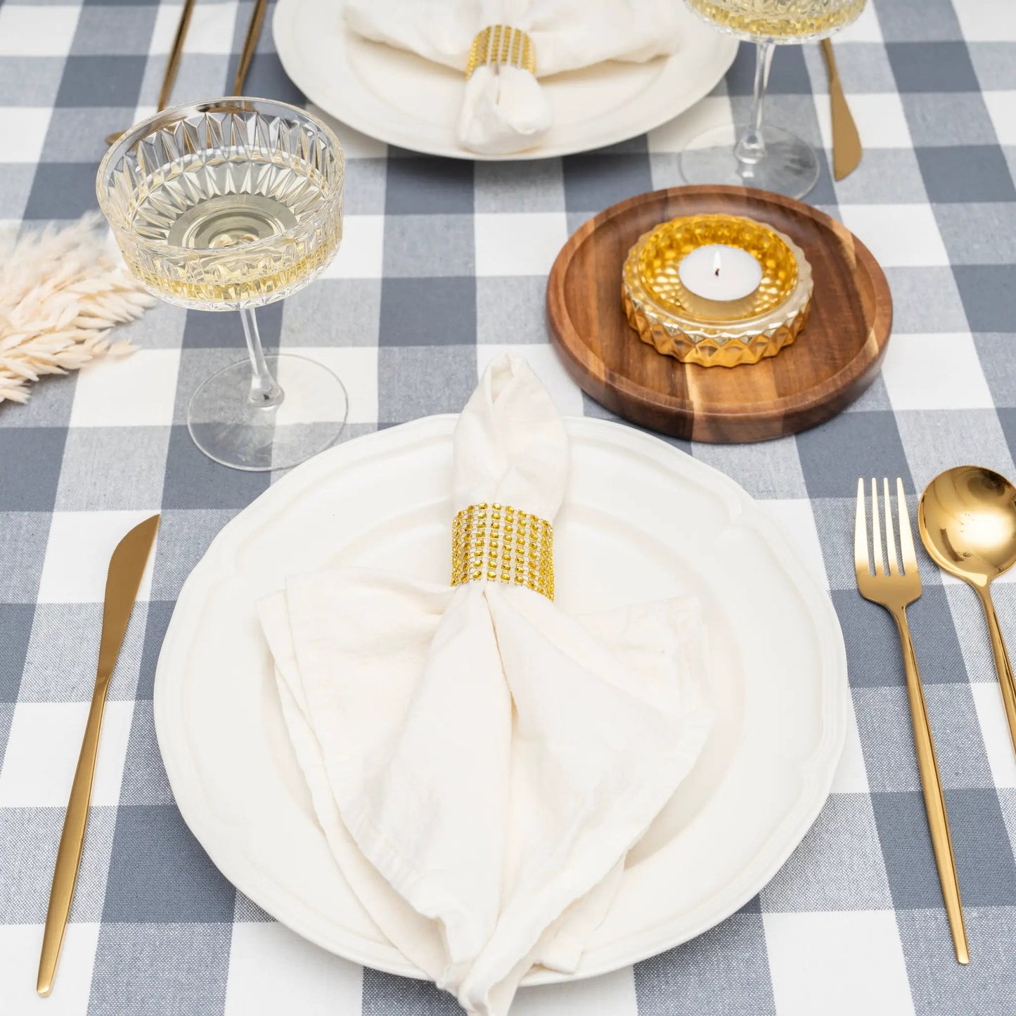 Plaid blue-and-white tablecloth for dining tables with white plate and gold flatware on Tampa Home & Garden Store
