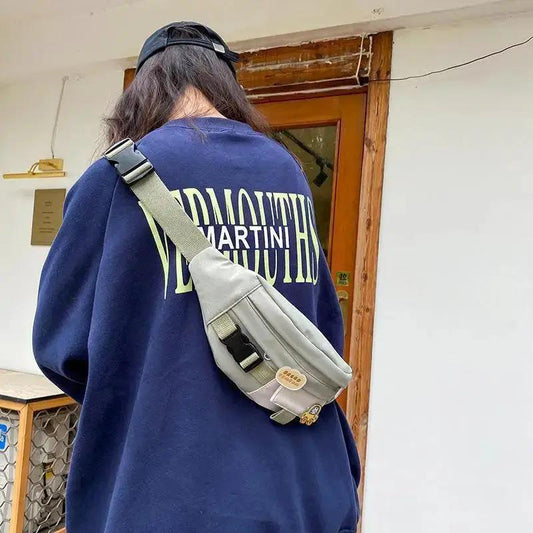 Fanny pack grey solid color with adjustable strap and front pocket by Stevvex worn crossbody on Tampa Home & Garden Store