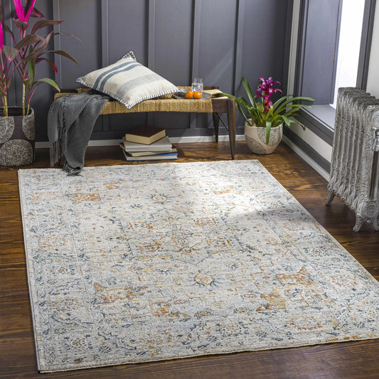 Darvel Luxe Rug by Boutique Rugs; teal, gray, mustard woven area rug in a cozy room with plants on Tampa Home & Garden Store