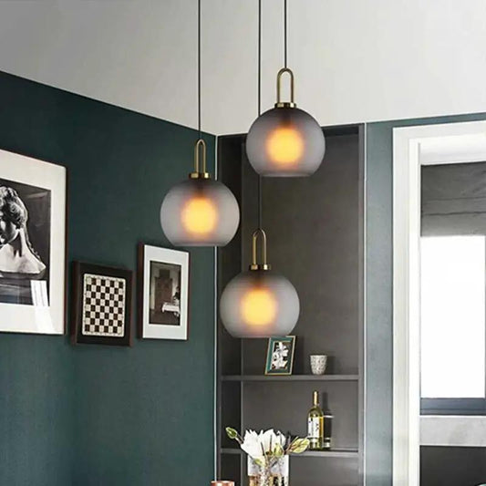 Nordic glass ball pendant chandeliers, frosted spheres with warm glow and brass hardware, trio on Tampa Home & Garden Store