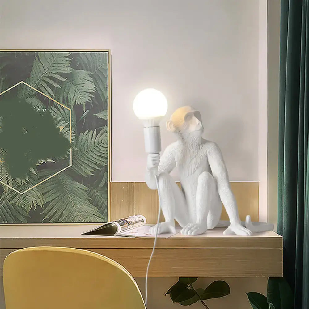 Resin Monkey Table Lamp in white, sculpted monkey holding a globe bulb by Decorbites on Tampa Home & Garden Store