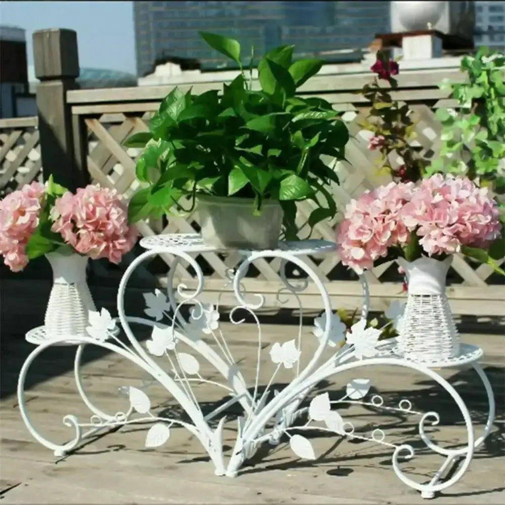 Classic Tall Plant Stand in White Wrought Iron with ornate vine detailing and greenery on top on Tampa Home & Garden Store