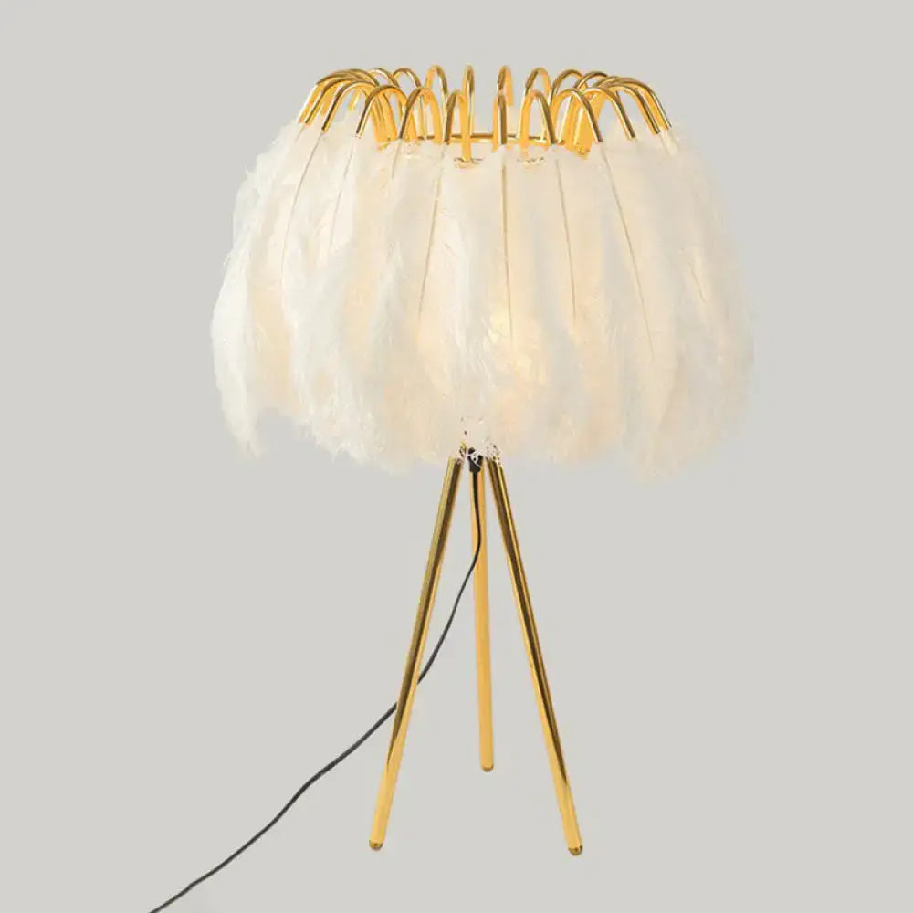 Gold feather table lamp with white feather shade on a gold tripod base on Tampa Home & Garden Store