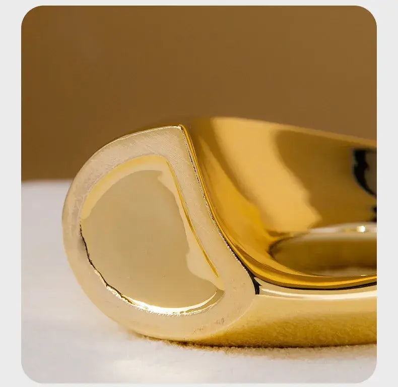 Golden ceramic flower vase by Decorbites with a glossy curved hollow form on Tampa Home & Garden Store