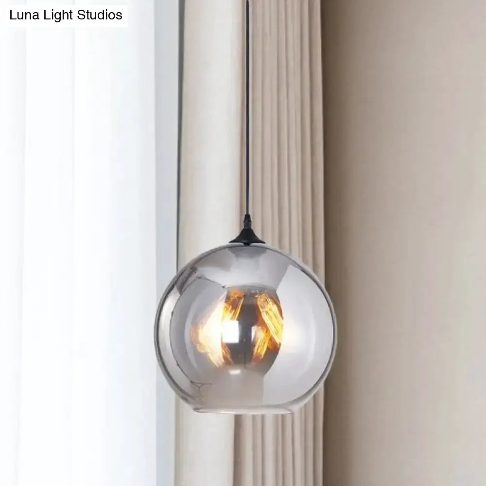 Industrial grey glass spherical pendant light with warm filament glow Decorbites on Tampa Home & Garden Store
