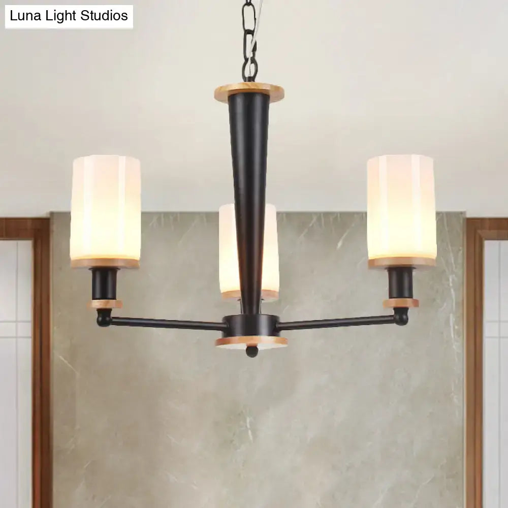 Black wood and glass chandelier with three glass shades on a three-arm frame on Tampa Home & Garden Store