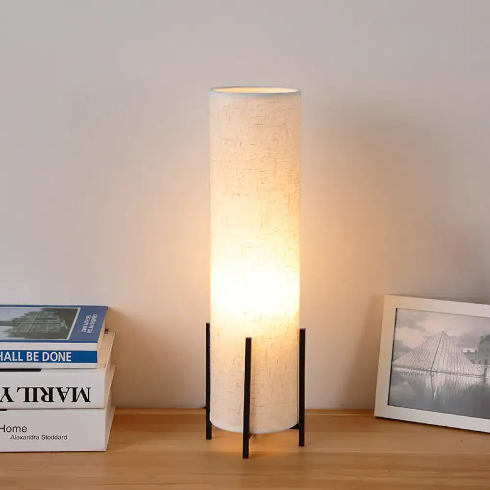 Beige fabric tubular dimmable reading lamp on a black metal stand by Decorbites on Tampa Home & Garden Store
