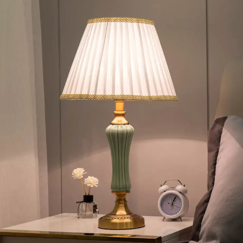 Green ceramic table lamp by Decorbites with a pleated white shade and gold-tone base on Tampa Home & Garden Store