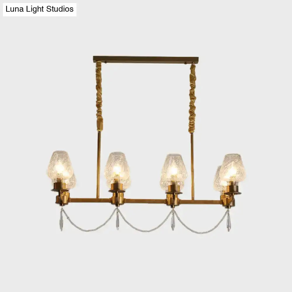 Modern brass crystal pendant island light with four candle-style glass shades and hanging crystals on Tampa Home & Garden Store