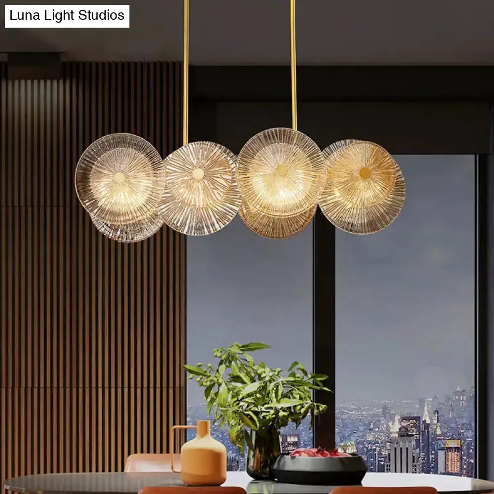 Modern gold finish pendant light with prismatic glass shade by Decorbites over table on Tampa Home & Garden Store