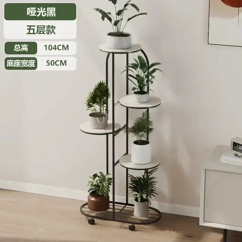 5-tier plant stand on wheels with matte black frame and white round shelves holding potted plants in living room Decorbites on Tampa Home & Garden Store