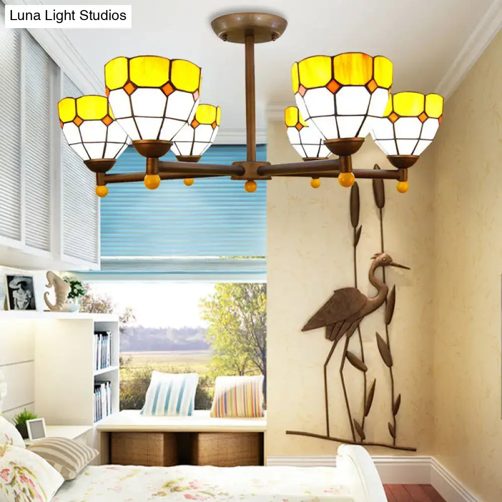 Amber stained glass chandelier with Tiffany-style yellow shades and bronze arms in bedroom on Tampa Home & Garden Store