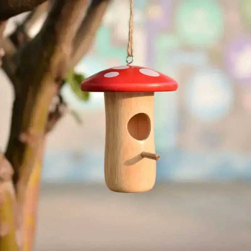 Wooden hanging hummingbird feeder with red mushroom cap and small perch on Tampa Home & Garden Store