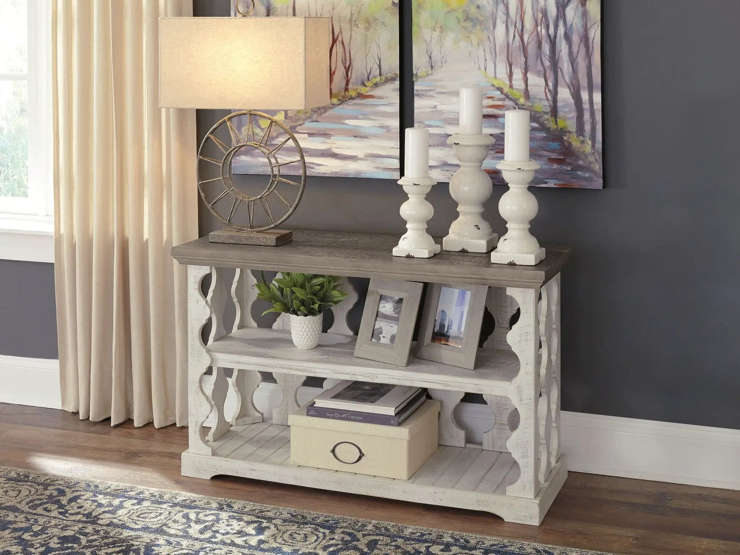 Havalance Console Sofa Table gray/white distressed finish with beige lamp and white candles on Tampa Home & Garden Store