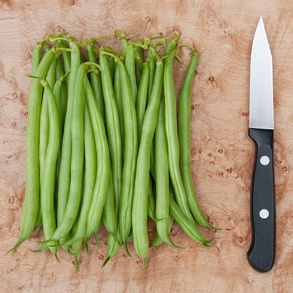 Strike Bush Bean Seeds, green bush bean pods arranged on a wooden cutting board beside a knife on Tampa Home & Garden Store