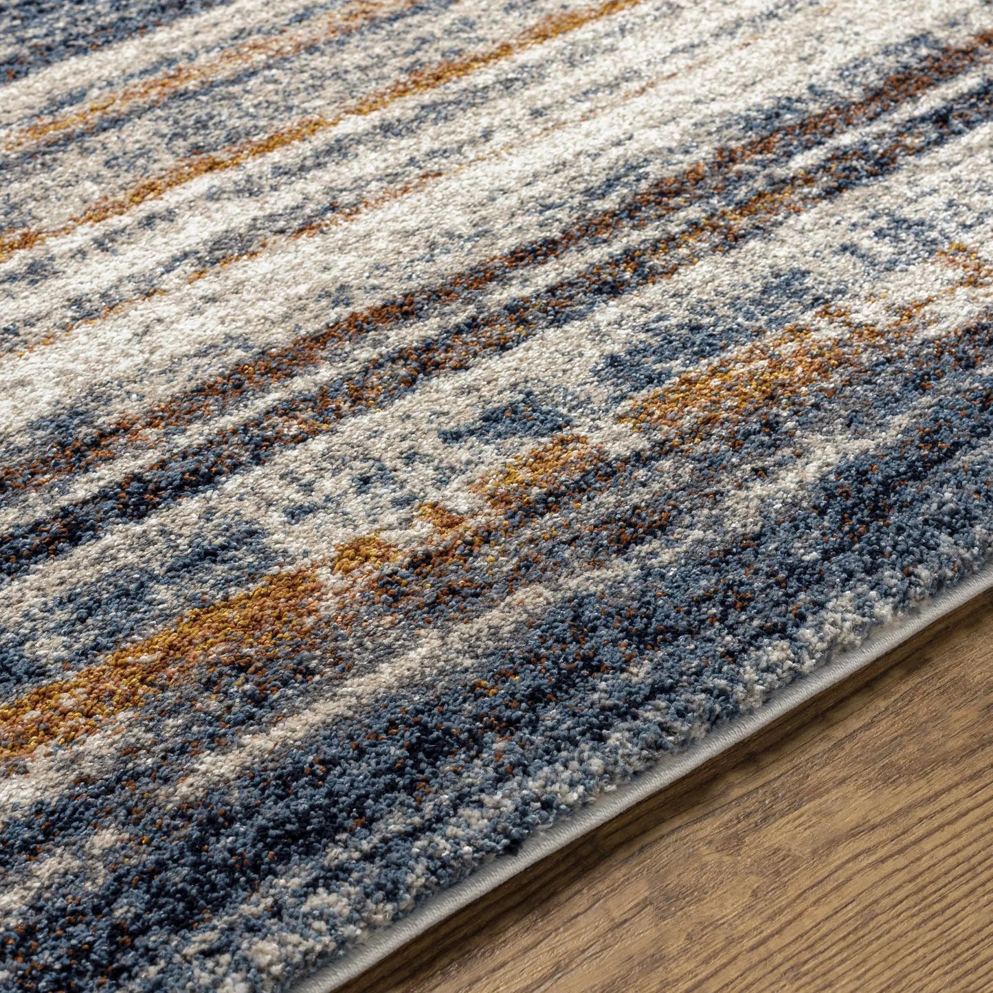 Dumaguil Thick Luxe Rug in blue and navy; textured pile with beige accents on wood floor on Tampa Home & Garden Store