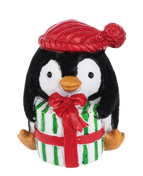 Christmas Penguin Pocket Charm ornament with red knit hat and striped green gift box on Tampa Home & Garden Store