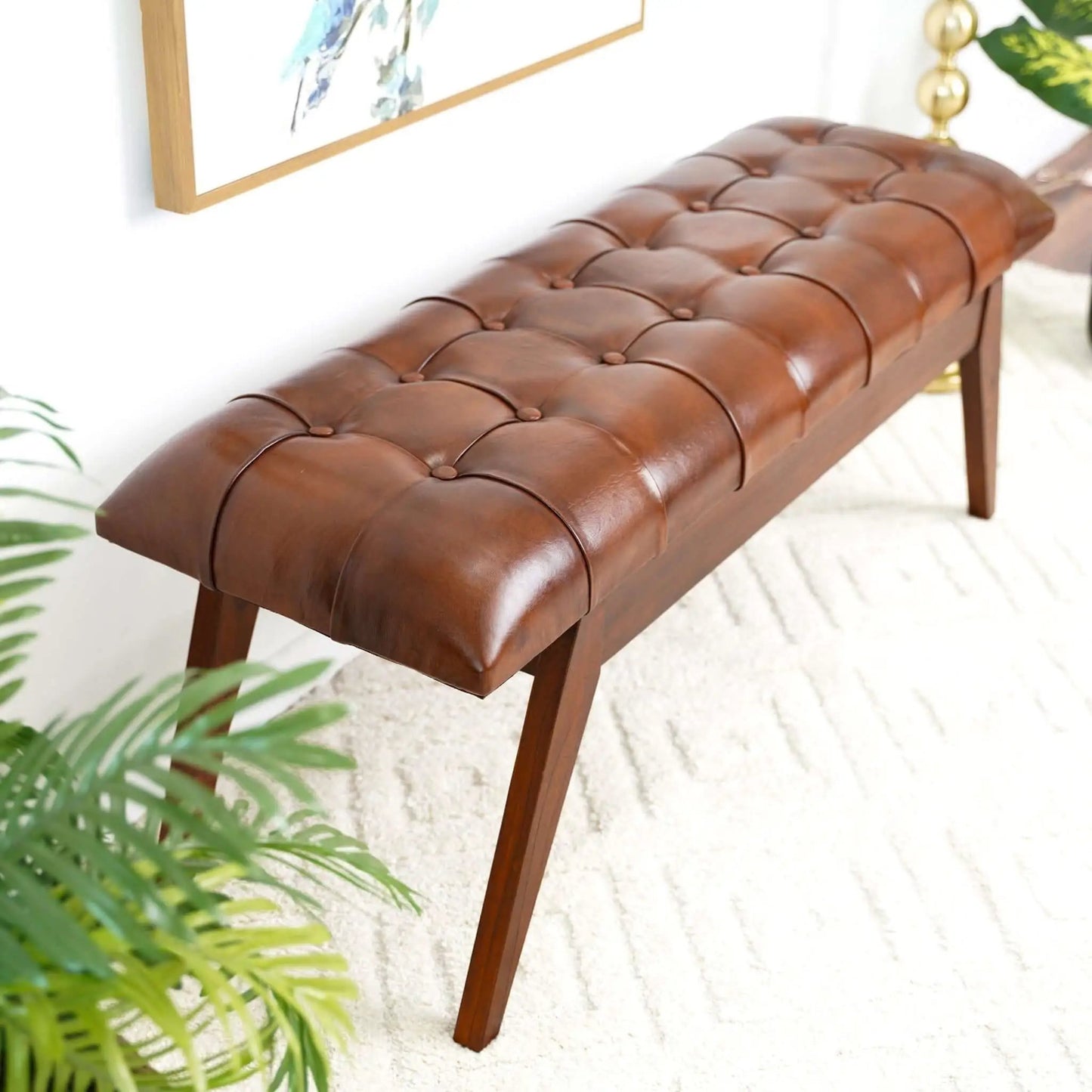 Maja bench by Unique Piece Furniture in cognac leather with tufted top and wooden legs on Tampa Home & Garden Store