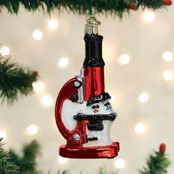 Microscope glass ornament with red base and black top hanging on a Christmas tree on Tampa Home & Garden Store