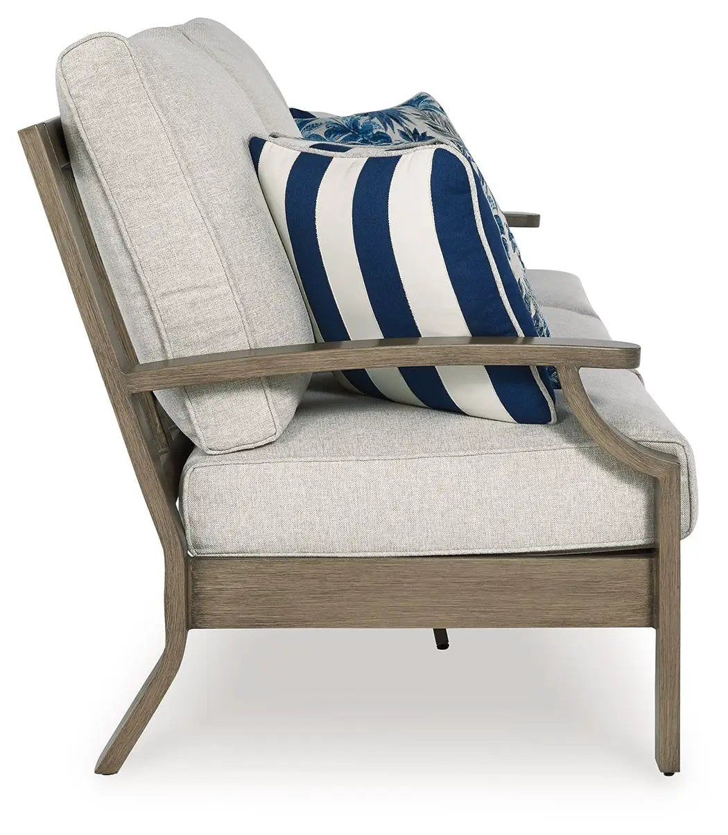 Rainier Ranch sofa with cushion; beige upholstery, brown wood frame, navy stripe pillow on Tampa Home & Garden Store