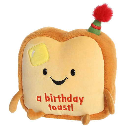 Just Sayin' Birthday Toast Plush with yellow bread face and green hat with red tuft on Tampa Home & Garden Store