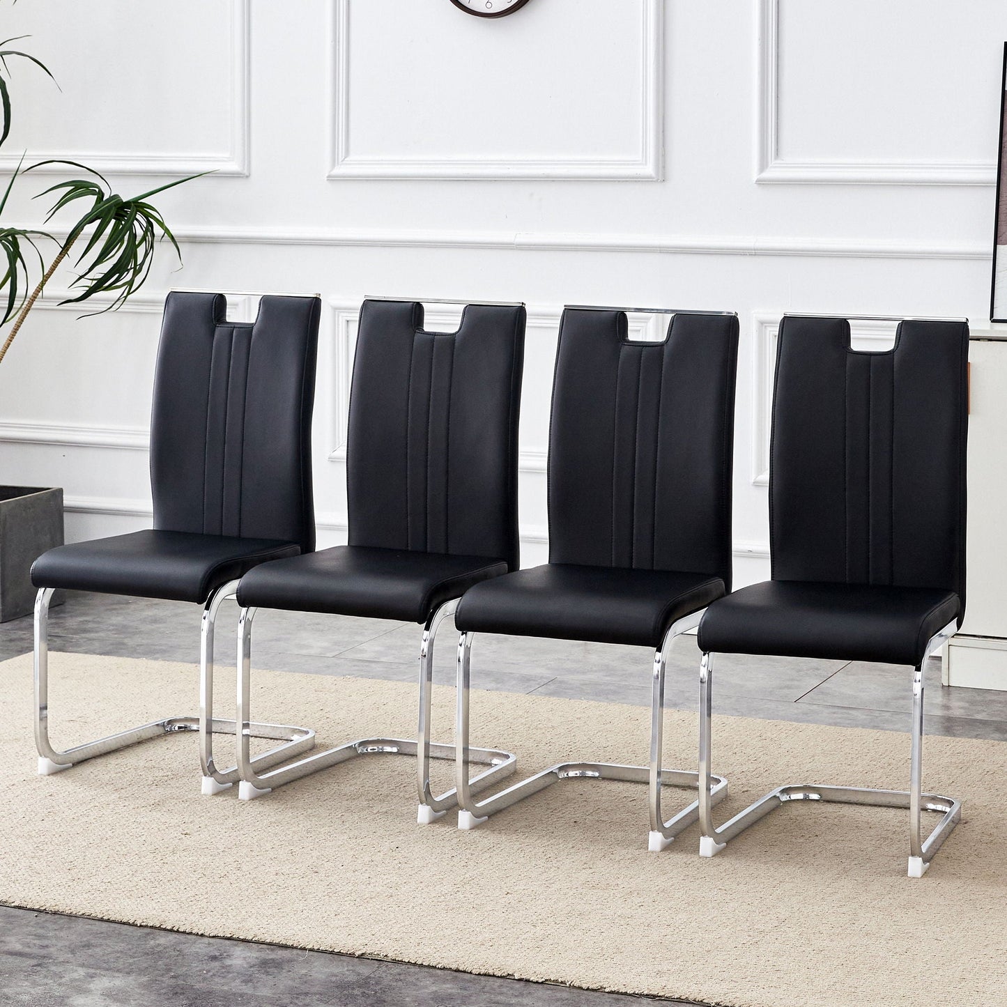 Bow shaped chairs in black faux leather with chrome legs and non slip bases on Tampa Home & Garden Store