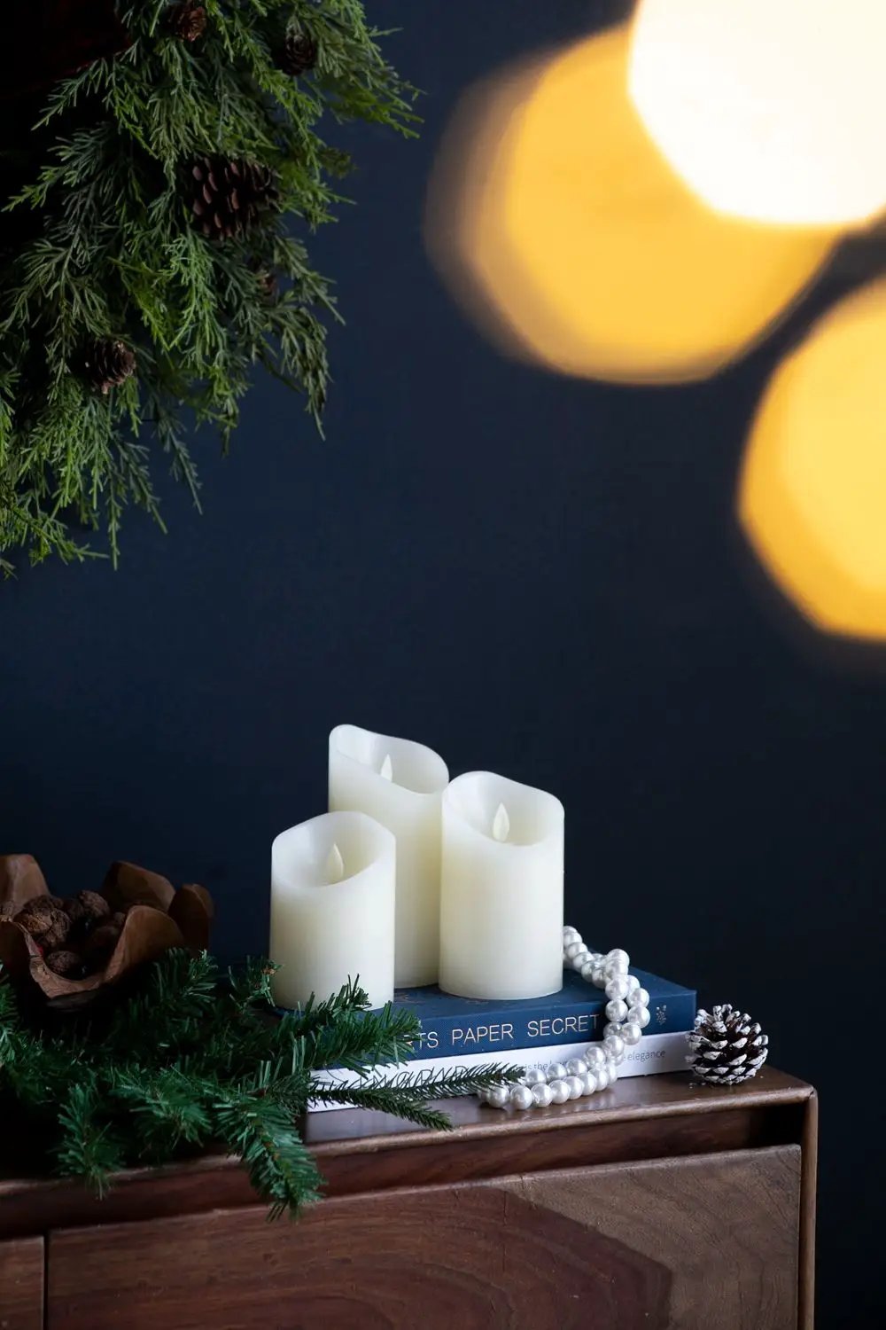 Ivory Flickering LED Candles Set of 3 by Unique Piece Furniture on a book stack with garland on Tampa Home & Garden Store