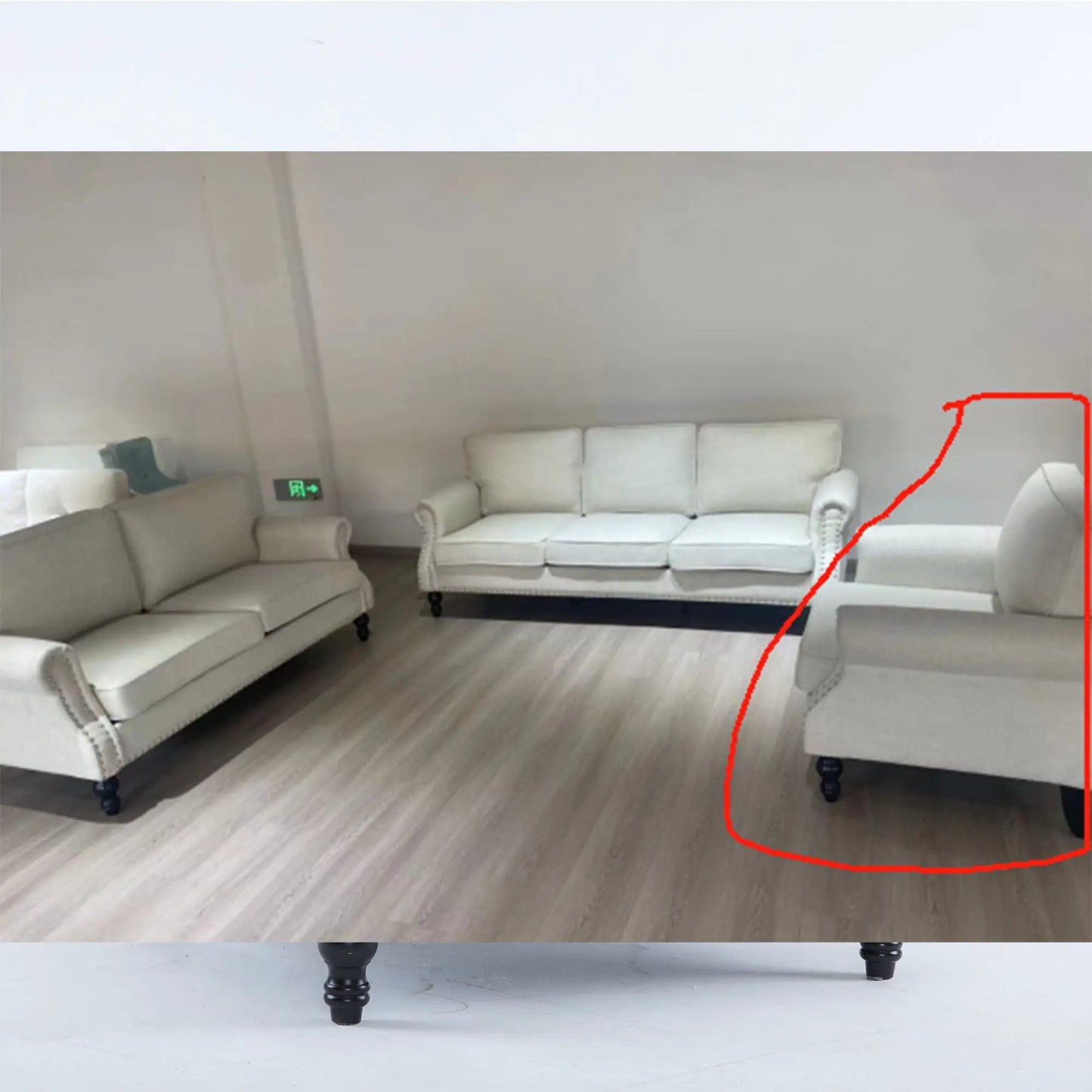 Rolled-arm cream sofa with nailhead trim, 1-seater on wooden legs in showroom on Tampa Home & Garden Store