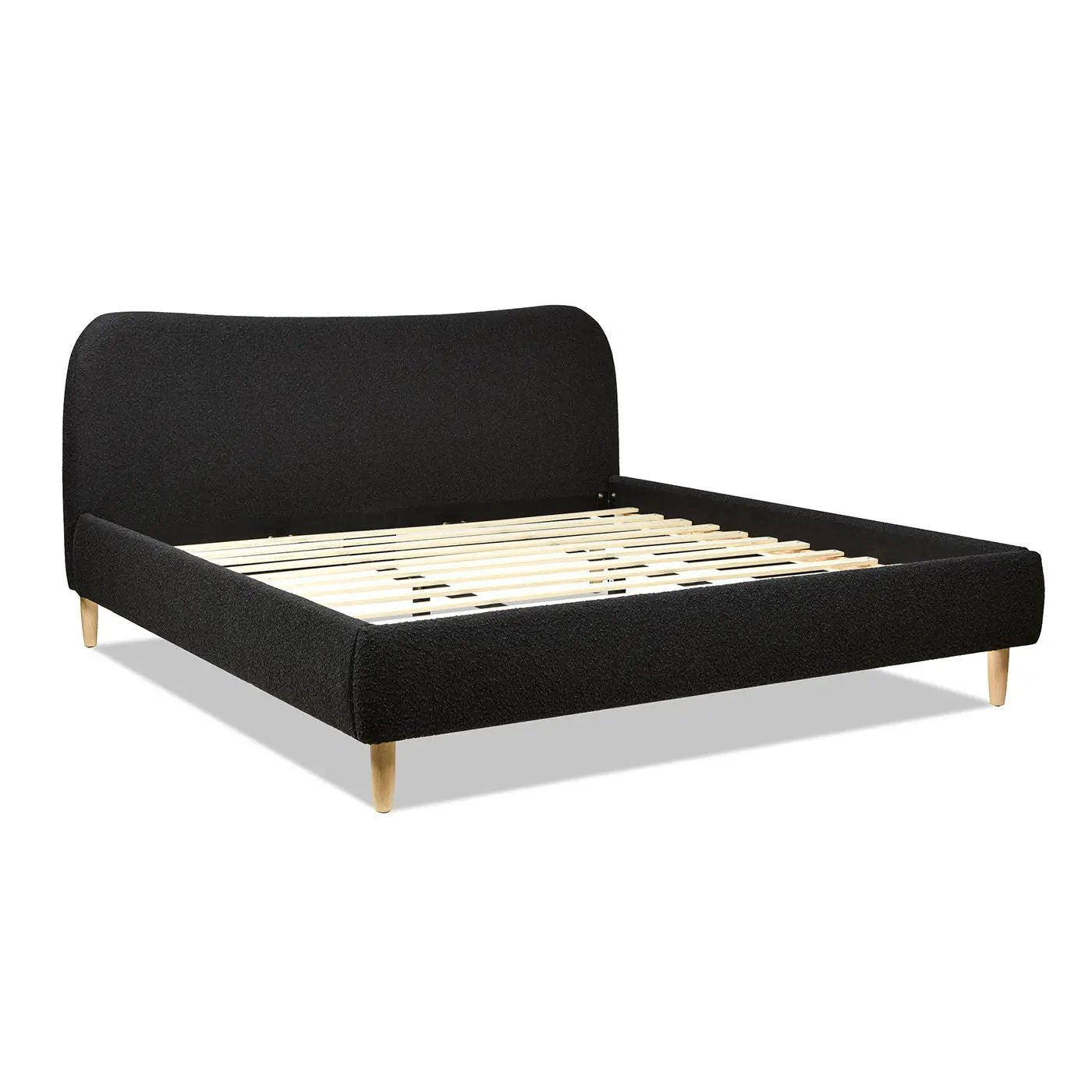 Roman curved headboard upholstered platform bed in black fabric with light wood legs on Tampa Home & Garden Store