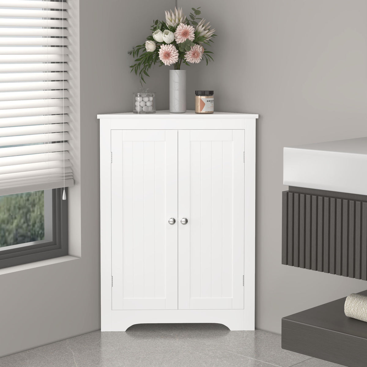 Corner cabinet with 2 white doors, narrow freestanding linen storage, top vase with pink flowers on Tampa Home & Garden Store