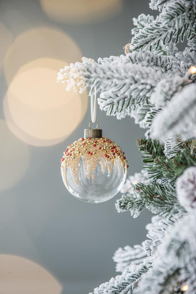 Christmas ball ornament with gold glitter drip and red bead accents on frosted tree on Tampa Home & Garden Store