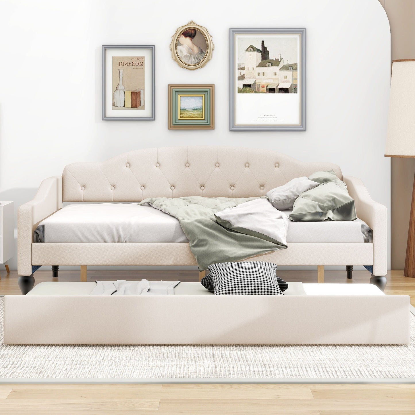 Upholstered tufted daybed in beige fabric with buttoned back and dark legs, wall art behind on Tampa Home & Garden Store