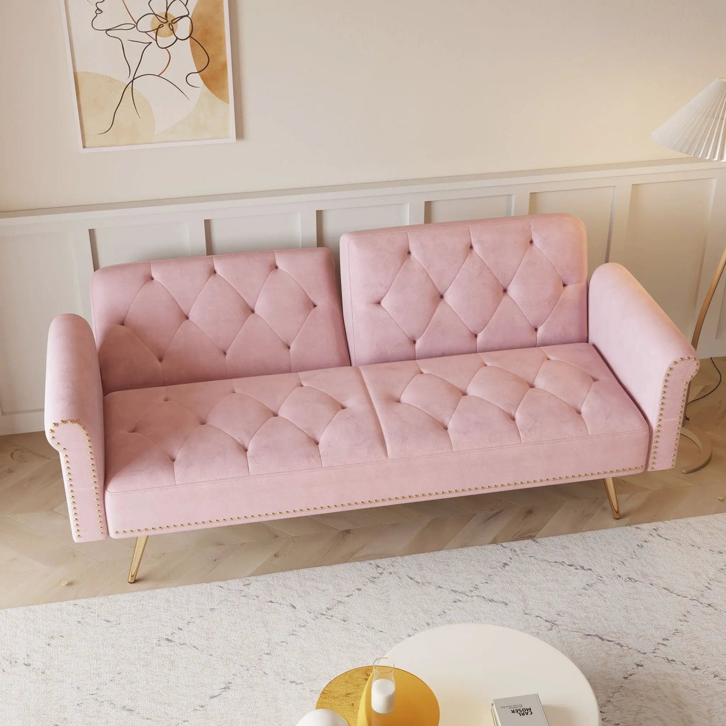 Pair of pink velvet tufted futon sofas with nailhead trim and light wood legs on Tampa Home & Garden Store