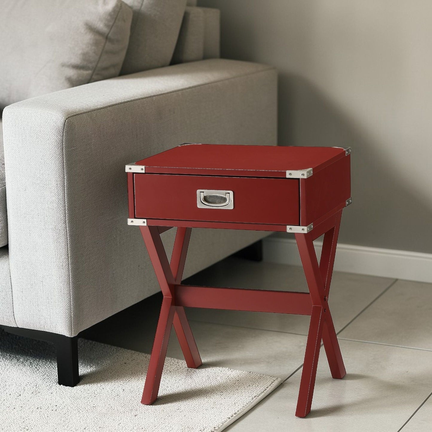 Red Babs accent table with metal corner brackets and angular legs beside a beige sofa on Tampa Home & Garden Store