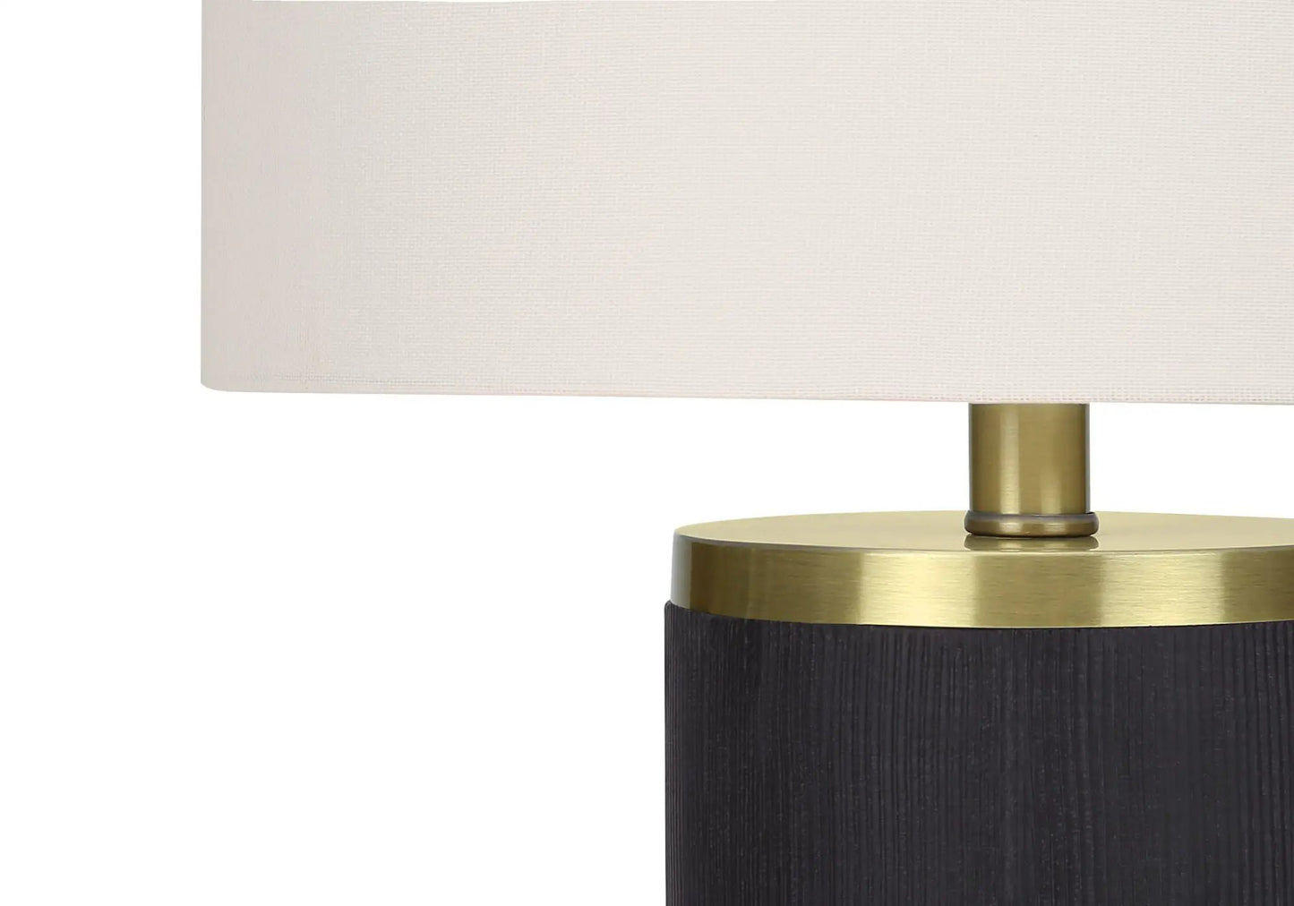 Table lamp with beige fabric shade, brass accents, and a black textured base on Tampa Home & Garden Store