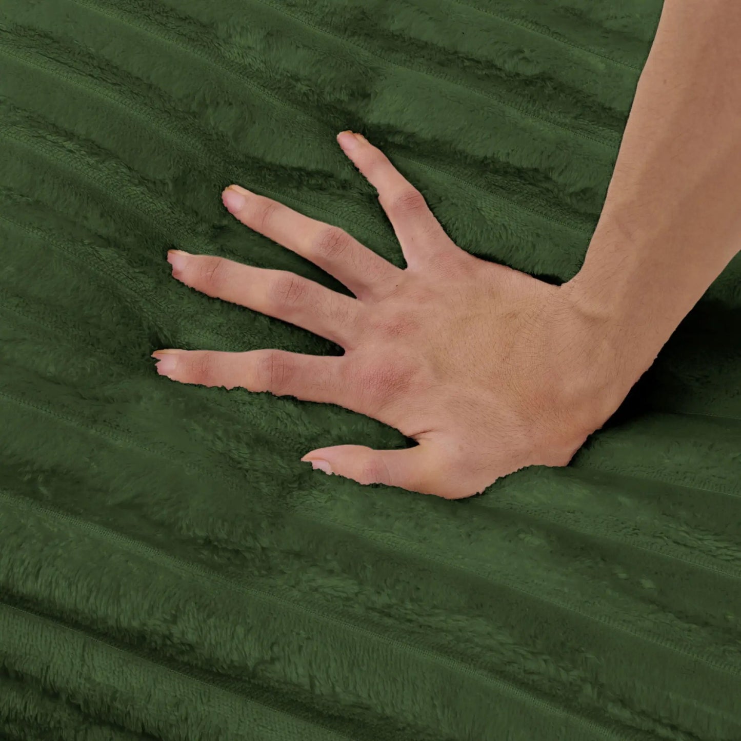 Chaises green plush fabric close-up with a hand pressing the deep seat surface on Tampa Home & Garden Store