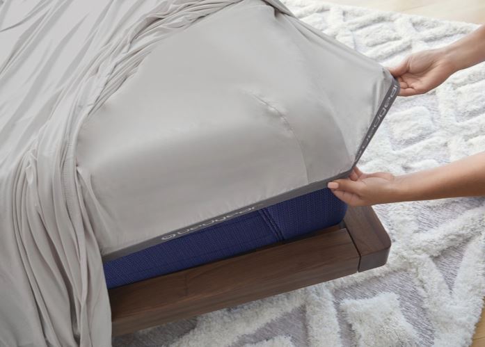 BedGear Vertex split Cal King sheet set in light grey atop a blue mattress on a wood frame on Tampa Home & Garden Store