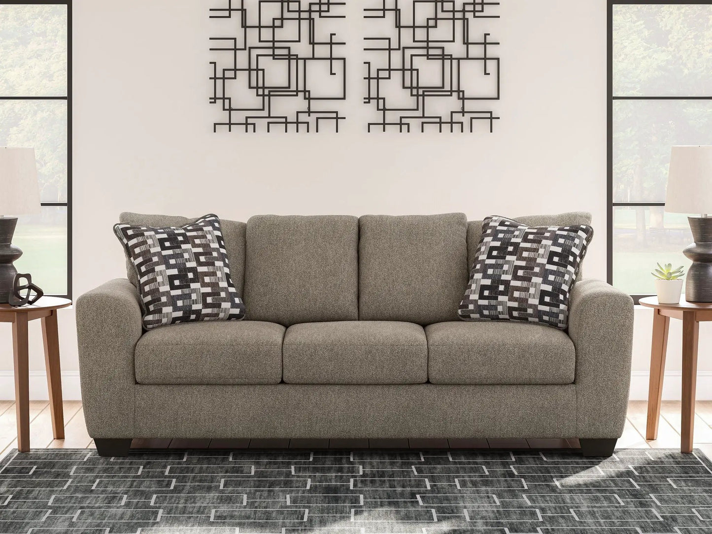 Triston-Peaks suede stationary sofa in gray upholstery with two geometric throw pillows on Tampa Home & Garden Store